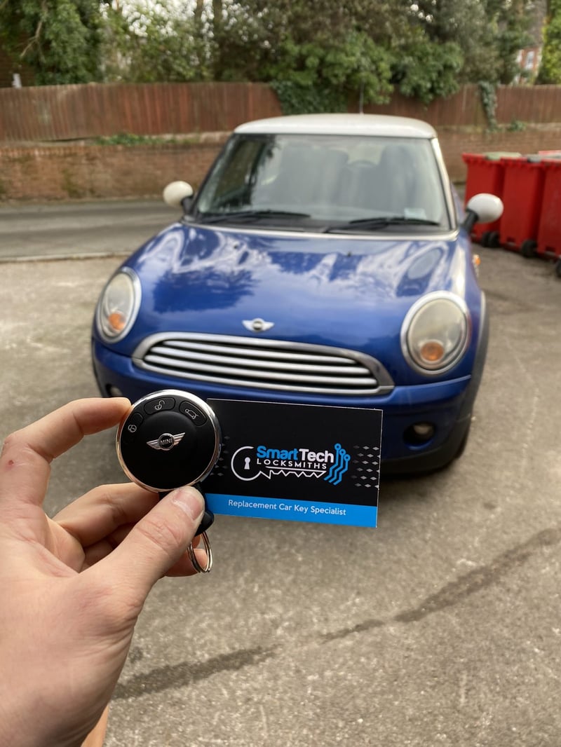 Mini replacement key in Southampton by SmartTech Auto Locksmiths, key and business card held in front of the vehicle