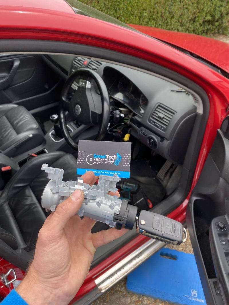 Hatchback ignition barrel replaced in New Forest by SmartTech Auto Locksmiths, key and business card held in front of the vehicle