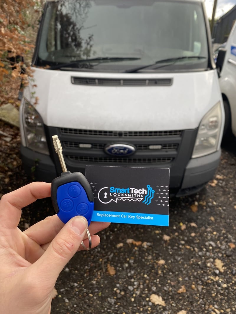 Ford Transit van remote key in Bishop's Waltham by SmartTech Auto Locksmiths, key and business card held in front of the vehicle