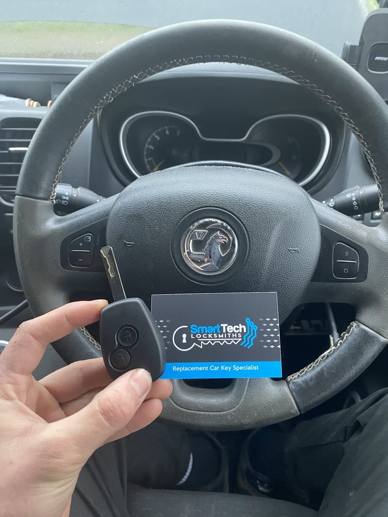 Vauxhall Vivaro van remote key in Fareham by SmartTech Auto Locksmiths, key and business card held in front of the vehicle