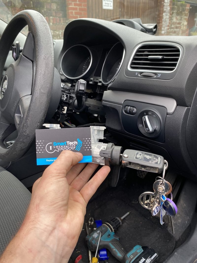 Volkswagen Golf ignition lock replaced in Gosport by SmartTech Auto Locksmiths, key and business card held in front of the vehicle