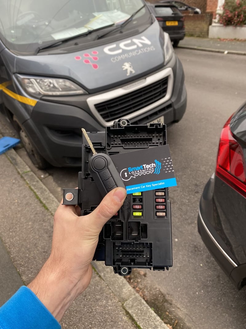 Peugeot Boxer van key and module repair in Eastleigh by SmartTech Auto Locksmiths, key and business card held in front of the vehicle