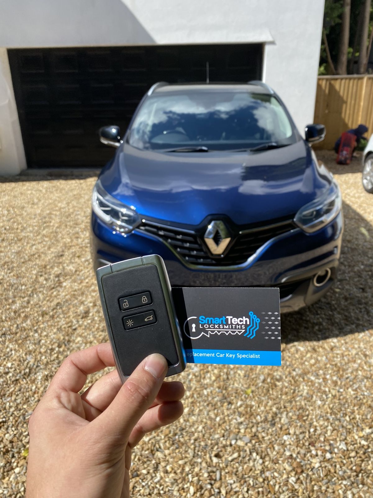 Renault Kadjar key card programmed in Fareham by SmartTech Auto Locksmiths, key and business card held in front of the vehicle