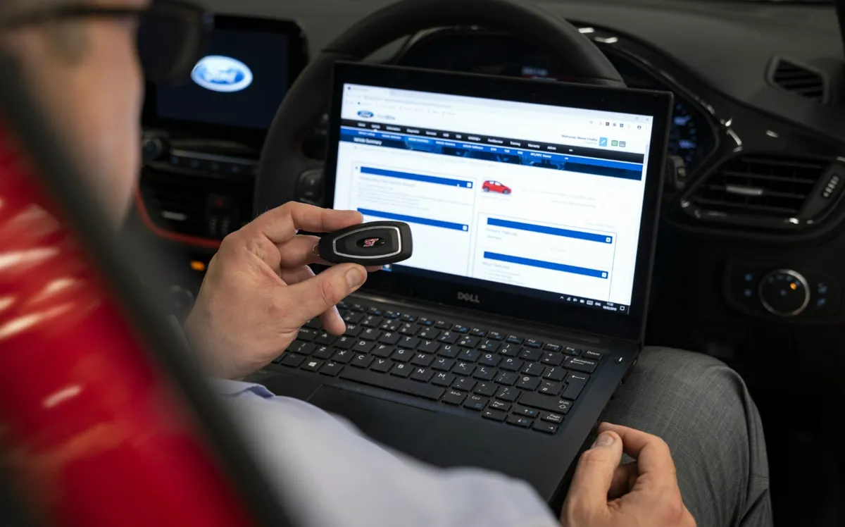 Car key being programmed with a diagnostic tablet