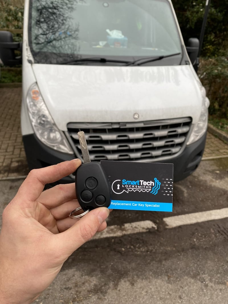 Renault Master van key cut and coded in Hampshire by SmartTech Auto Locksmiths, key and business card held in front of the vehicle