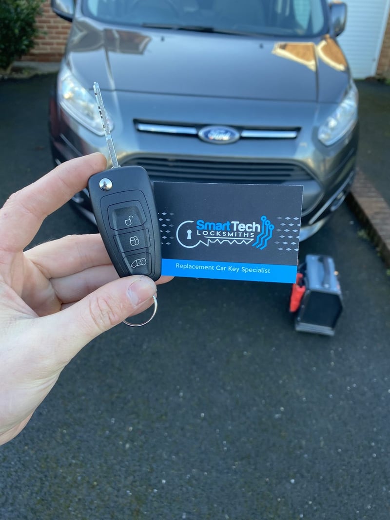 Ford Tourneo Connect flip key cut and coded in Hedge End by SmartTech Auto Locksmiths, key and business card held in front of the vehicle