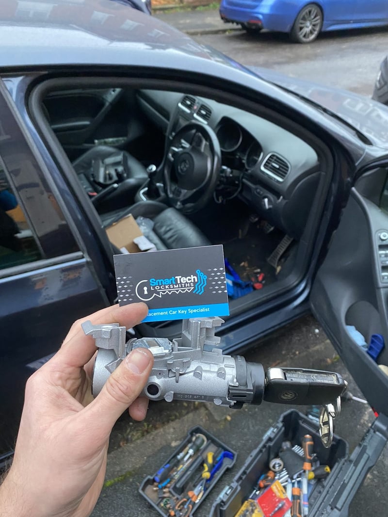 Volkswagen Golf ignition lock replaced in Shirley by SmartTech Auto Locksmiths, key and business card held in front of the vehicle