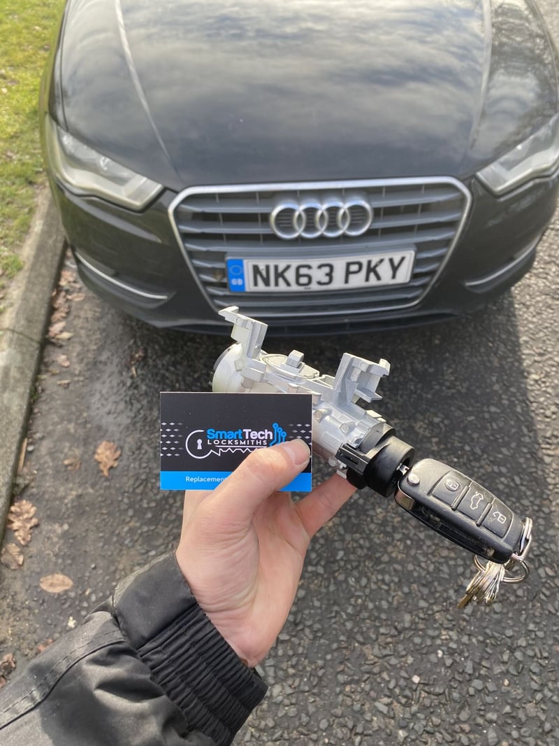 Audi A3 ignition barrel and key in Southampton by SmartTech Auto Locksmiths, key and business card held in front of the vehicle