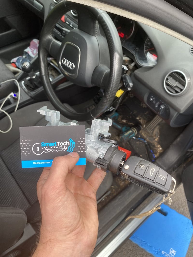 Audi A3 ignition lock replaced in Hampshire by SmartTech Auto Locksmiths, key and business card held in front of the vehicle
