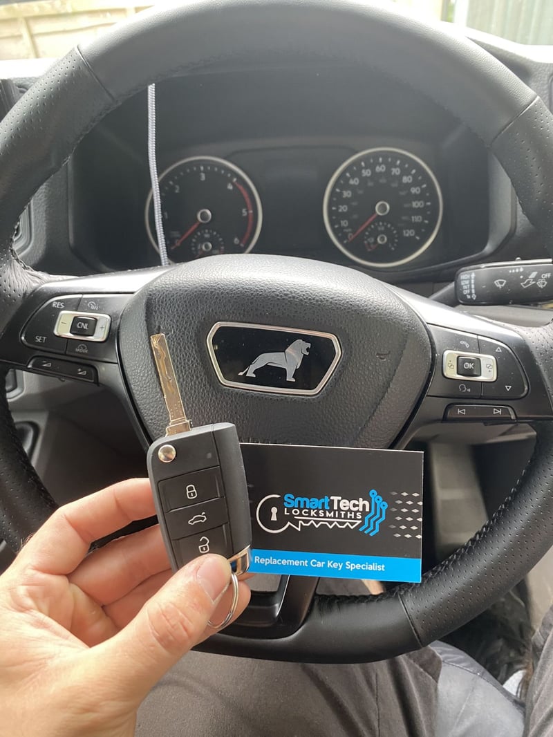 Peugeot van remote flip key programmed in Portsmouth by SmartTech Auto Locksmiths, key and business card held in front of the vehicle